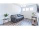 Living room with gray couch, hardwood floors, and a console table at 2406 Ninebark Dr, Plainfield, IN 46168