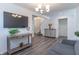 Open living room with hardwood floors, a gray couch, and a view of the staircase at 2406 Ninebark Dr, Plainfield, IN 46168