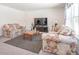 Living room with floral sofas and a large TV at 2406 Ninebark Dr, Plainfield, IN 46168