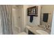 Clean bathroom with updated vanity, granite counter top, walk-in shower, and decorative shelving at 2420 Rippling Creek Ct, Westfield, IN 46074