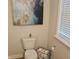 Stylish powder room featuring a toilet, modern fixtures, and decor at 2420 Rippling Creek Ct, Westfield, IN 46074