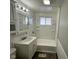 Clean bathroom with white vanity, tub, and shower at 2442 Asbury St, Indianapolis, IN 46203