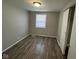 Bright bedroom with wood-look floors and a closet at 2442 Asbury St, Indianapolis, IN 46203