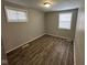 Spacious bedroom featuring wood-look floors and large windows at 2442 Asbury St, Indianapolis, IN 46203