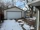 Detached garage with brick driveway and snow on the ground at 2442 Asbury St, Indianapolis, IN 46203