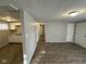 Open living room and kitchen with dark wood-look floors at 2442 Asbury St, Indianapolis, IN 46203