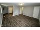 Spacious living room with dark wood-look floors and neutral walls at 2442 Asbury St, Indianapolis, IN 46203
