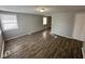 Spacious living room with dark wood-look floors and neutral walls at 2442 Asbury St, Indianapolis, IN 46203