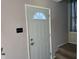 Front entry with gray door and carpeted stairs at 2507 Redland Ln, Indianapolis, IN 46217