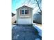 Tan two-story house with a white garage door and orange shutters at 2507 Redland Ln, Indianapolis, IN 46217