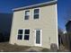 Tan two-story home with a door and windows at 2507 Redland Ln, Indianapolis, IN 46217