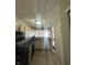 Kitchen with light wood cabinets, black appliances, and tile floors at 2507 Redland Ln, Indianapolis, IN 46217