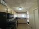 Kitchen with light wood cabinets, black appliances and tile floors at 2507 Redland Ln, Indianapolis, IN 46217