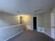 Loft bedroom with carpeted floors and access to bathroom at 2507 Redland Ln, Indianapolis, IN 46217