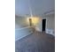 Loft bedroom with carpeted floors and access to bathroom at 2507 Redland Ln, Indianapolis, IN 46217