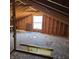 Unfinished attic space with exposed beams, plywood walls, and a window providing natural light at 2509 W Euclid Ave, Muncie, IN 47304