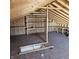 Unfinished attic with wooden beams and built-in shelving for extra storage at 2509 W Euclid Ave, Muncie, IN 47304