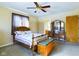 Main bedroom with ceiling fan, wooden furniture, and carpeted floors at 2509 W Euclid Ave, Muncie, IN 47304