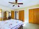 Main bedroom with ceiling fan, double doors, and carpeted floors at 2509 W Euclid Ave, Muncie, IN 47304