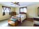 Bedroom with ceiling fan, wooden furniture, and carpeted floors at 2509 W Euclid Ave, Muncie, IN 47304