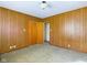 Bedroom with wood paneled walls and neutral carpeting at 2509 W Euclid Ave, Muncie, IN 47304