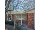 Inviting front porch of a red brick house with a view of the garden at 2509 W Euclid Ave, Muncie, IN 47304