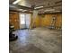 Spacious garage with a ladder, ample storage, and a rear door with a well-lit interior at 2509 W Euclid Ave, Muncie, IN 47304