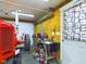 A red tractor is parked inside the garage next to a workbench at 2509 W Euclid Ave, Muncie, IN 47304