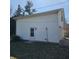 Side view of a detached garage with a white door and white siding at 2509 W Euclid Ave, Muncie, IN 47304