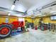A well-lit workshop with a classic red tractor and various tools at 2509 W Euclid Ave, Muncie, IN 47304