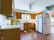 Kitchen with wood cabinets, tile floor, and white appliances at 2509 W Euclid Ave, Muncie, IN 47304