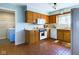 Kitchen boasts wood cabinets, tile floor, and laundry access at 2509 W Euclid Ave, Muncie, IN 47304