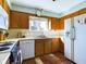 Kitchen features wood cabinets, white appliances, and tile floor at 2509 W Euclid Ave, Muncie, IN 47304