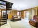 Living room with spiral staircase, wood paneling, and a view of kitchen at 2509 W Euclid Ave, Muncie, IN 47304