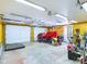 Spacious workshop with tractor, tools, and ample overhead lighting at 2509 W Euclid Ave, Muncie, IN 47304