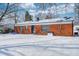 View of the home's backyard with a brick exterior and a fresh blanket of snow at 3647 Richelieu Rd, Indianapolis, IN 46226