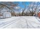 Snowy backyard with shed and trees, perfect for winter outdoor activities at 3647 Richelieu Rd, Indianapolis, IN 46226