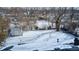 View of the home's backyard with a detached shed and a fresh blanket of snow at 3647 Richelieu Rd, Indianapolis, IN 46226