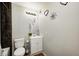 Cozy bathroom featuring a toilet, vanity with storage, and decorative wall art at 3647 Richelieu Rd, Indianapolis, IN 46226