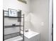 Bright bathroom features a white sink and black shelving with beach-themed decor at 3647 Richelieu Rd, Indianapolis, IN 46226