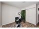 A simple bedroom setup has an adjacent door and lighting for practicality at 3647 Richelieu Rd, Indianapolis, IN 46226