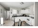 Efficient eat-in kitchen features a cozy dining area and practical layout with white cabinets at 3647 Richelieu Rd, Indianapolis, IN 46226