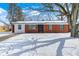 Charming brick home with a well-maintained yard and beautiful tree in a winter setting at 3647 Richelieu Rd, Indianapolis, IN 46226