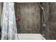 Bathroom shower with gray tile and a handheld shower head offers a modern design at 3647 Richelieu Rd, Indianapolis, IN 46226