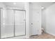 Modern bathroom featuring a sleek glass-enclosed shower, light wood flooring, and white subway tile at 385 N Post Oak Dr, Mooresville, IN 46158
