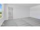 Bright bedroom with soft gray carpeting and a view of the bathroom and tub at 385 N Post Oak Dr, Mooresville, IN 46158
