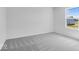 A clean and bright bedroom with neutral walls and plush gray carpeting at 385 N Post Oak Dr, Mooresville, IN 46158