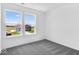 A bright bedroom with carpeted floors, with a view of the neighborhood at 385 N Post Oak Dr, Mooresville, IN 46158
