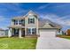 Charming two-story home with green siding, a well-manicured lawn, and a two-car garage at 385 N Post Oak Dr, Mooresville, IN 46158