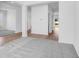 Open-concept living room boasts sleek hardwood and plush carpet flooring with bright white trim at 385 N Post Oak Dr, Mooresville, IN 46158